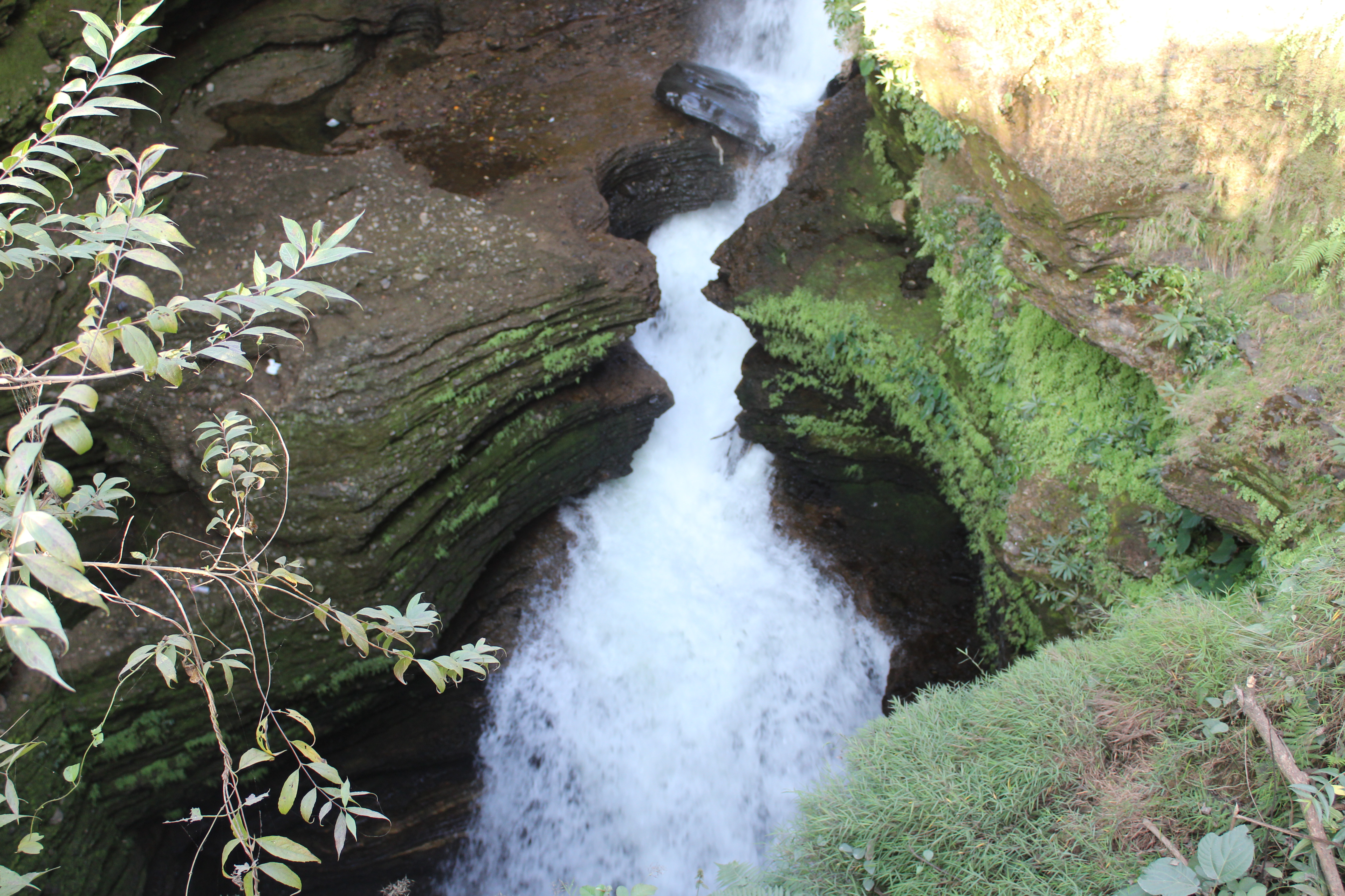 Water dropping into the narrow rock channel at Devi’s Fall Pokhara